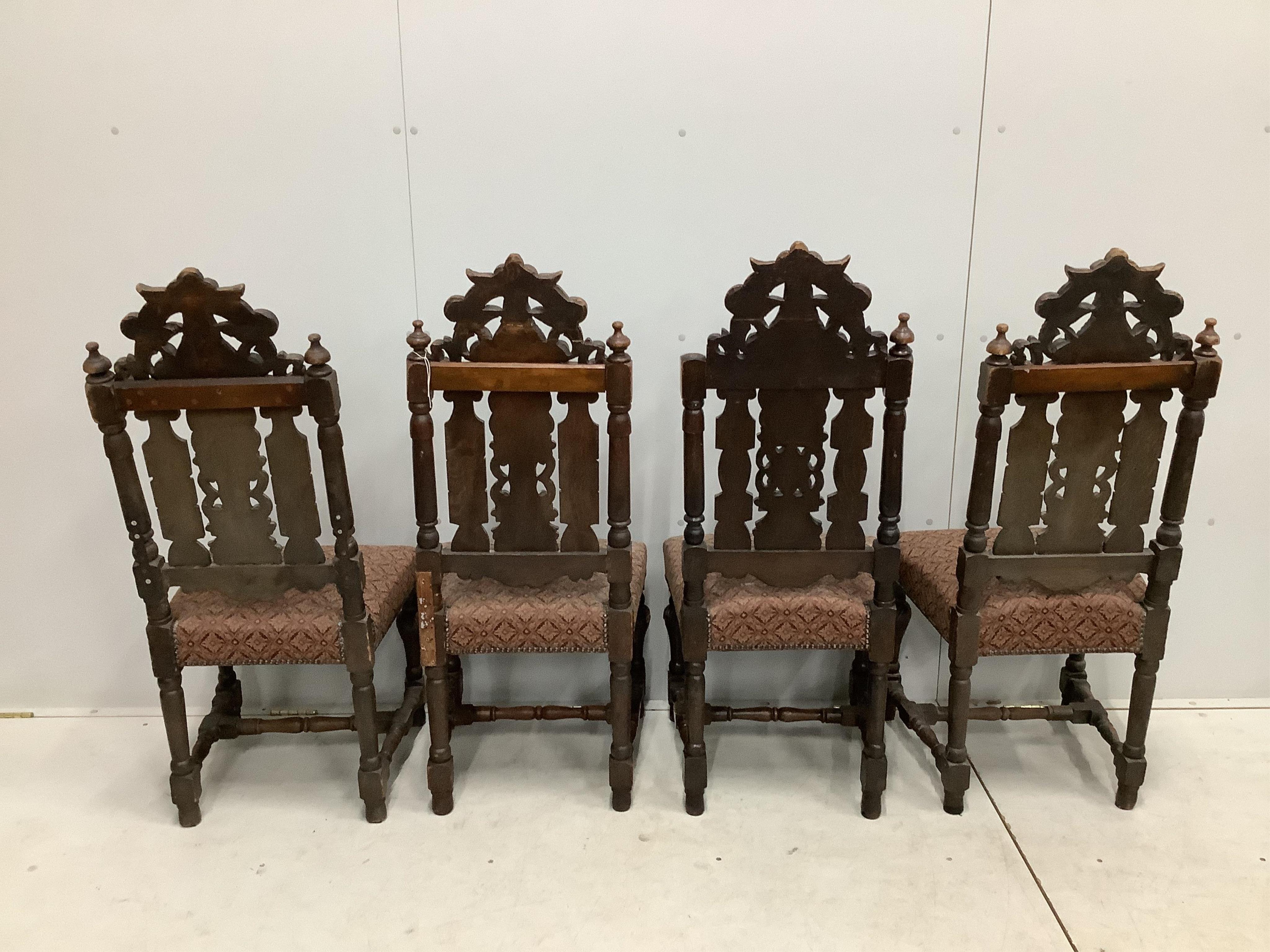 A set of thirteen carved Victorian oak dining chairs, one with arms. Condition - poor to fair